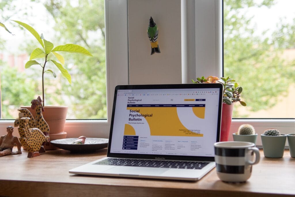 a laptop on a desk open to a web design or web marketing